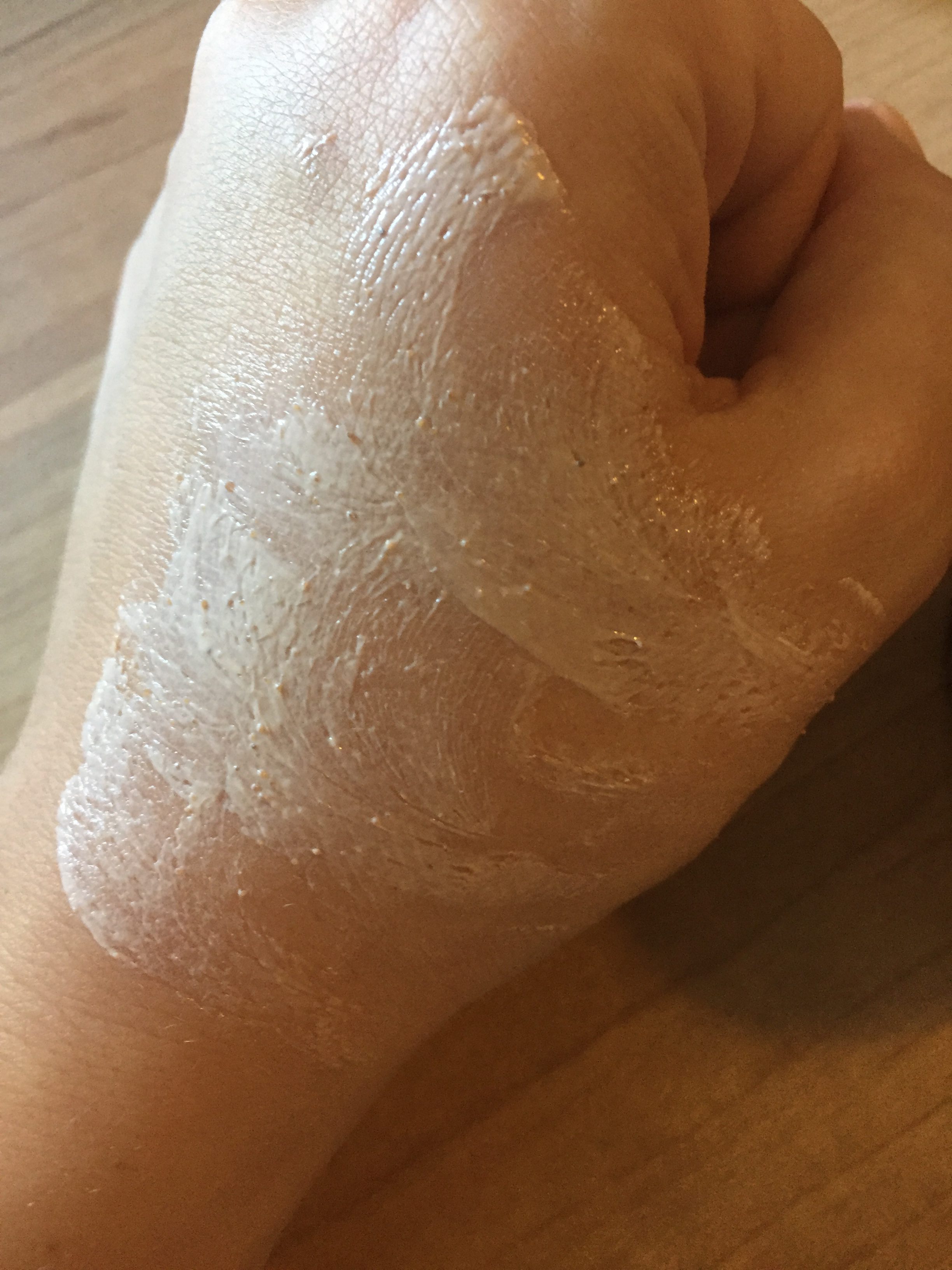pink clay mask spread on hand