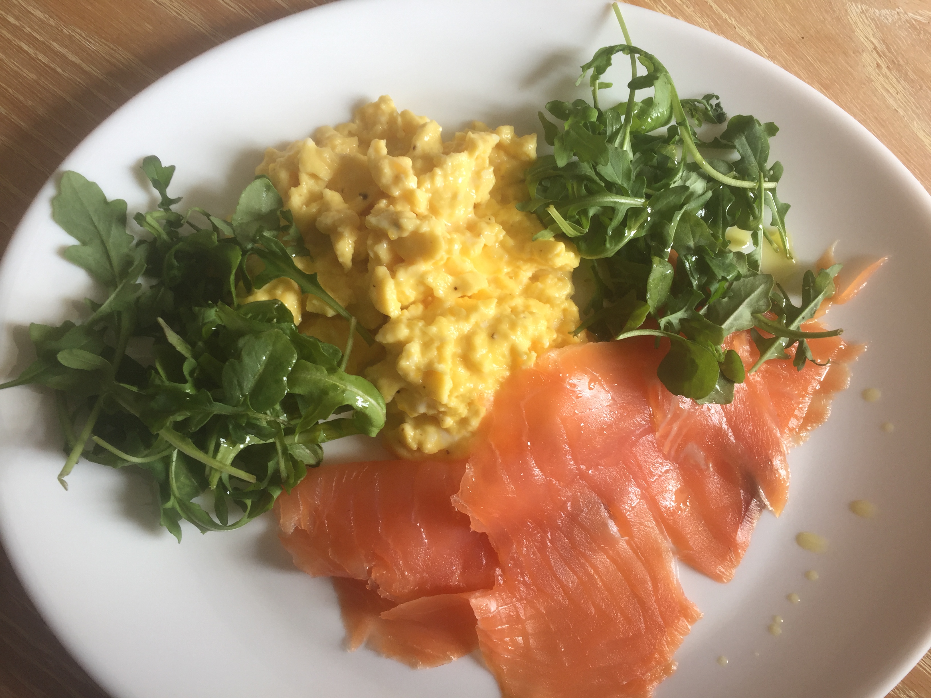 Smoked salmon with scrambled eggs and rocket salad