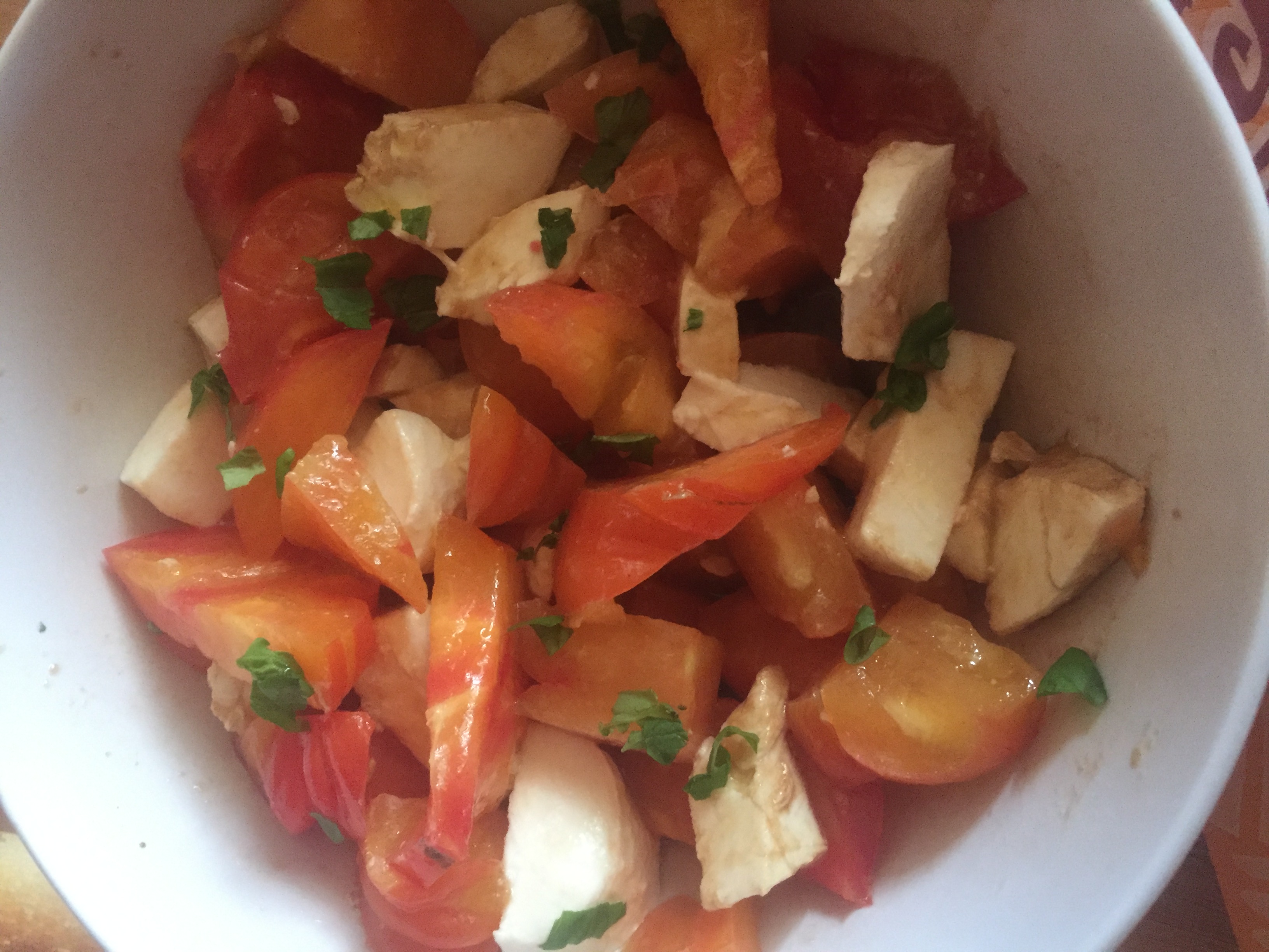 tomatoes and mozzarella in olive oil with basil