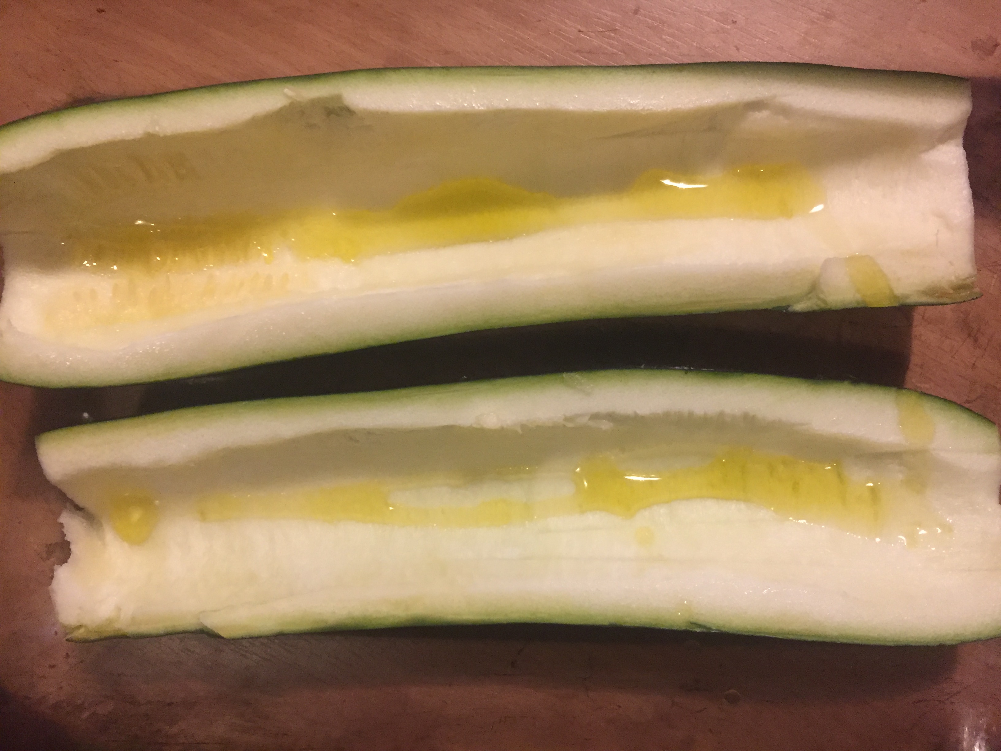 Low Carb Chicken Zucchini Boats scraped out with olive oil