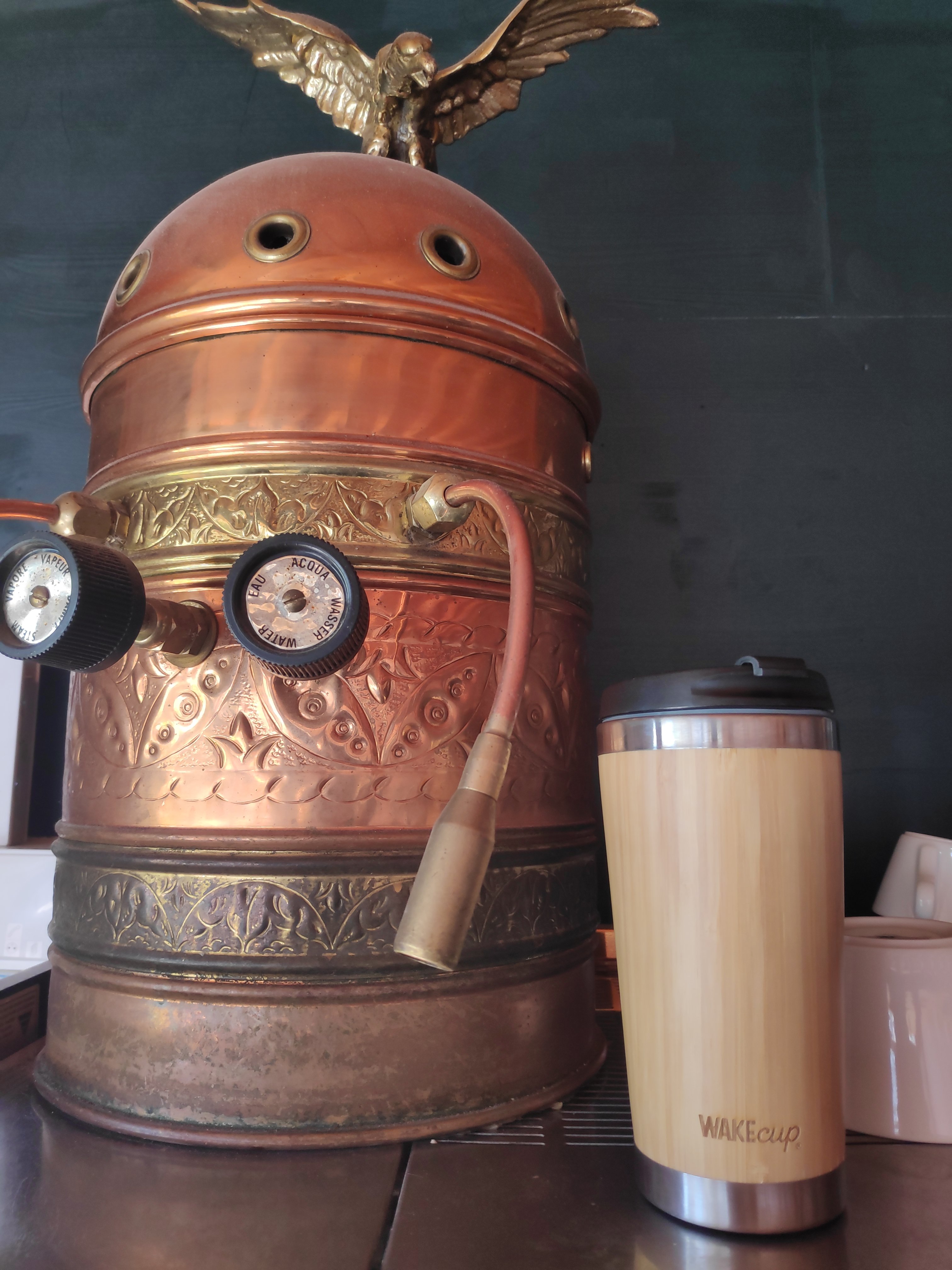 reusable coffee mug and vintage coffee machine